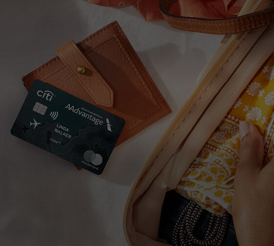 Citi® / AAdvantage® Globe™ Mastercard® next to wallet and vacation essentials